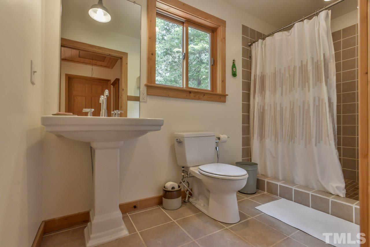 8710 Morrow Mill Road Mebane, NC 27302 - Photo 14 of 24 Second floor bathroom has a tiled walk-in shower.