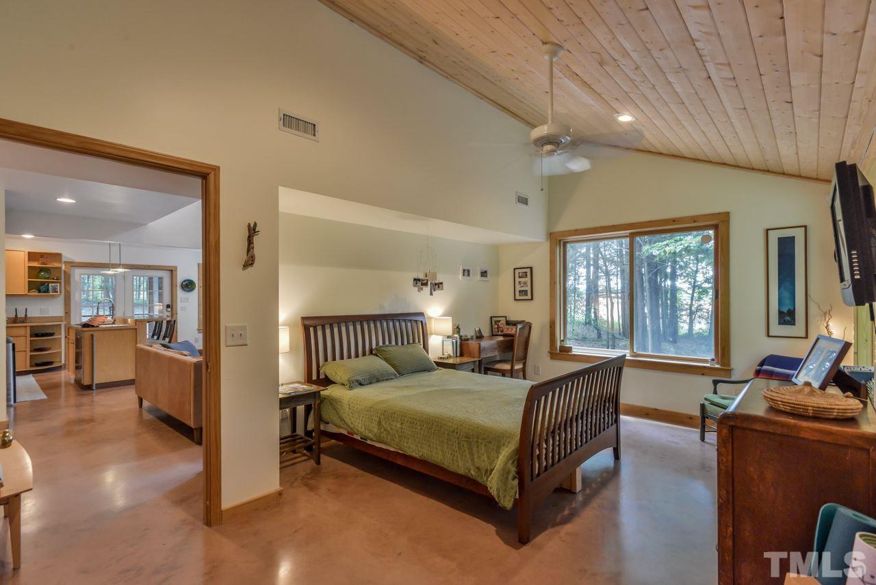 8710 Morrow Mill Road Mebane, NC 27302 - Photo 9 of 24 Main level master bedroom option with vaulted tongue and groove ceiling and large closet. Would also make a great den, study or studio for those with other ideas.