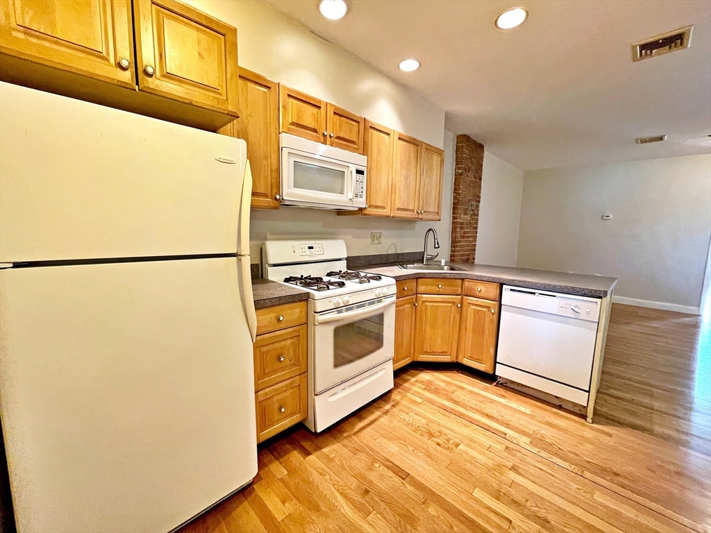 64 Trenton Street Boston, MA 02128 - Photo 17 of 34 a kitchen with stainless steel appliances a refrigerator sink and cabinets