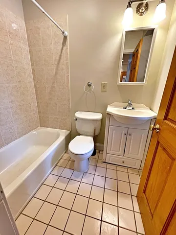 a bathroom with a sink a toilet and bathtub