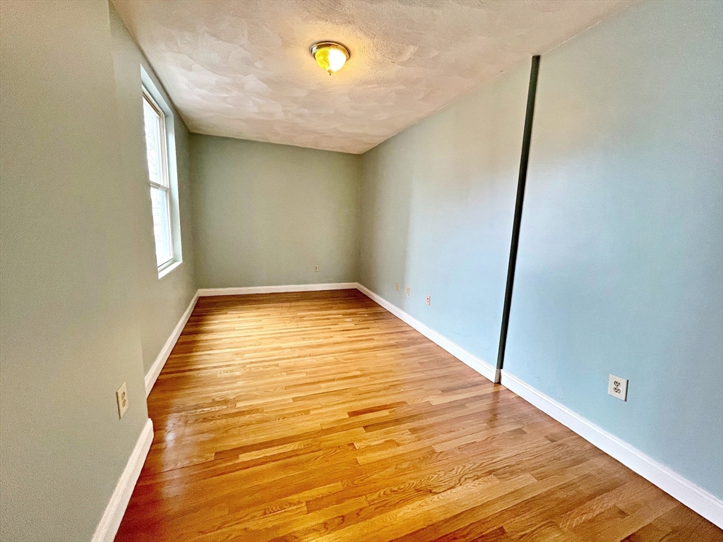 64 Trenton Street Boston, MA 02128 - Photo 25 of 34 a view of empty room with wooden floor