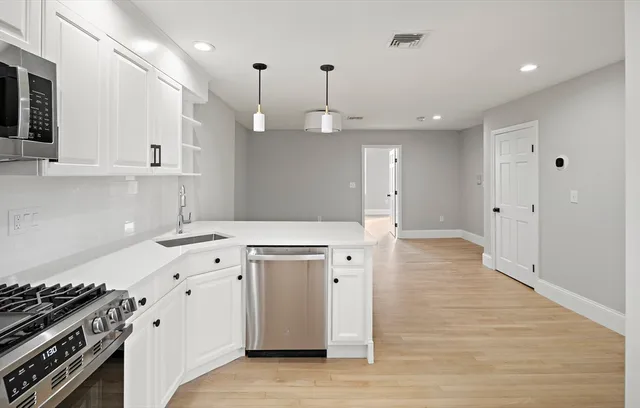 a kitchen with a stove a sink and a refrigerator