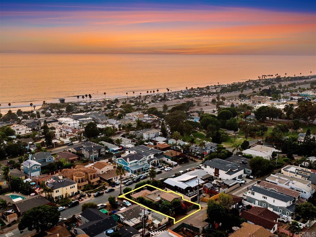 an aerial view of a city and ocean view