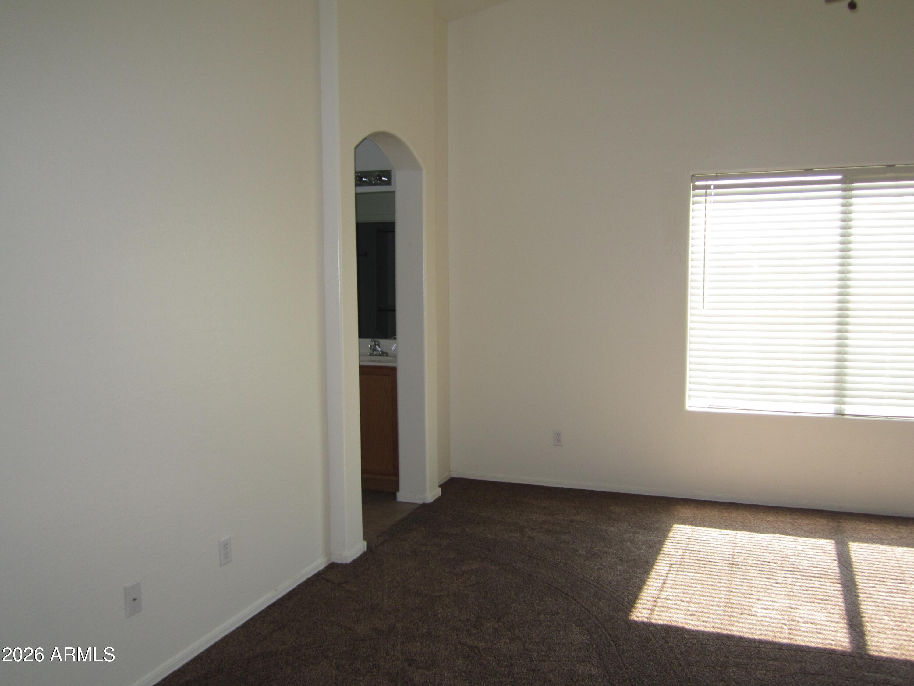 18671 North Madison Road Maricopa, AZ 85139 - Photo 17 of 27 an empty room with windows