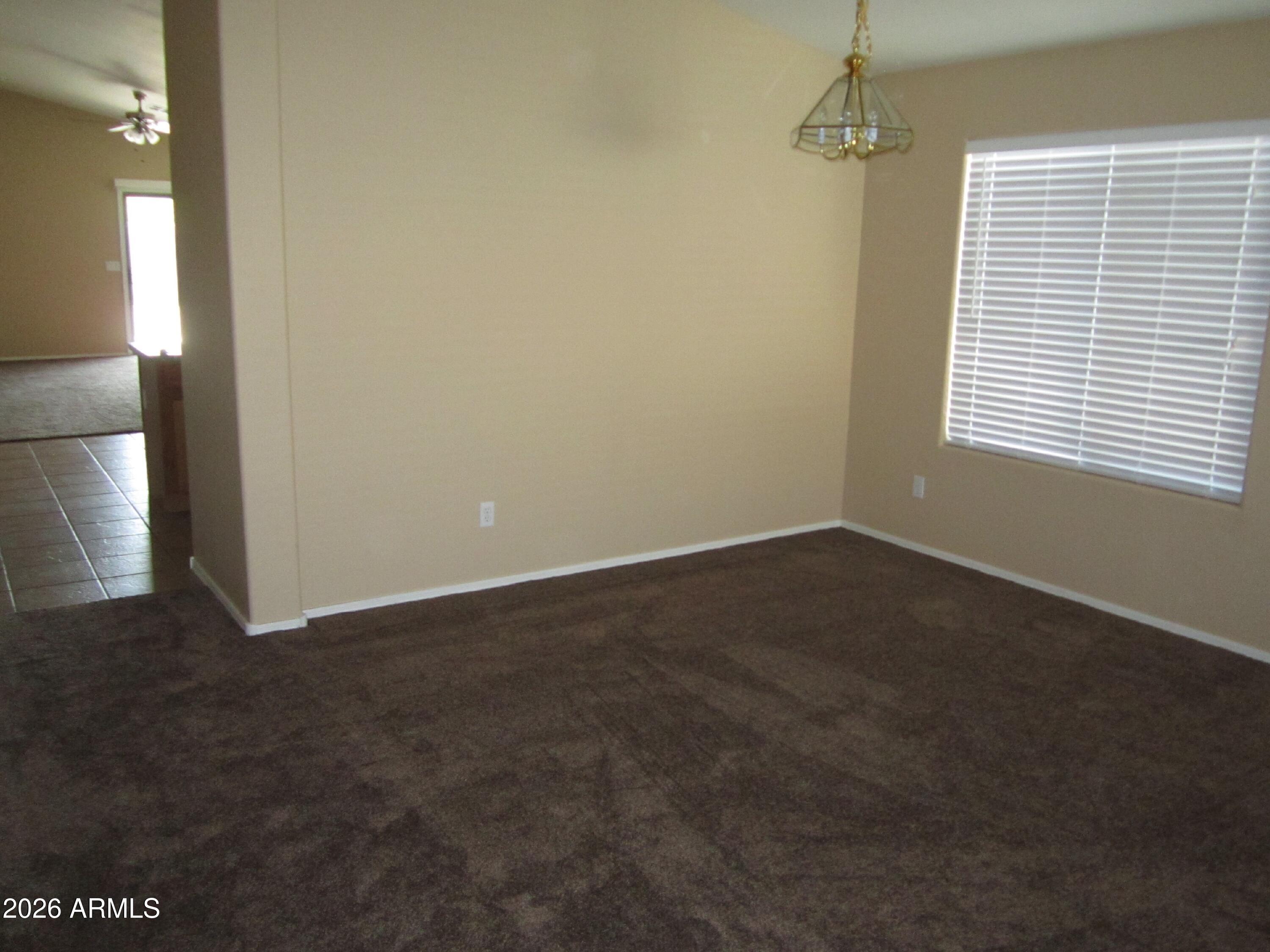 18671 North Madison Road Maricopa, AZ 85139 - Photo 8 of 27 a view of an empty room with a window
