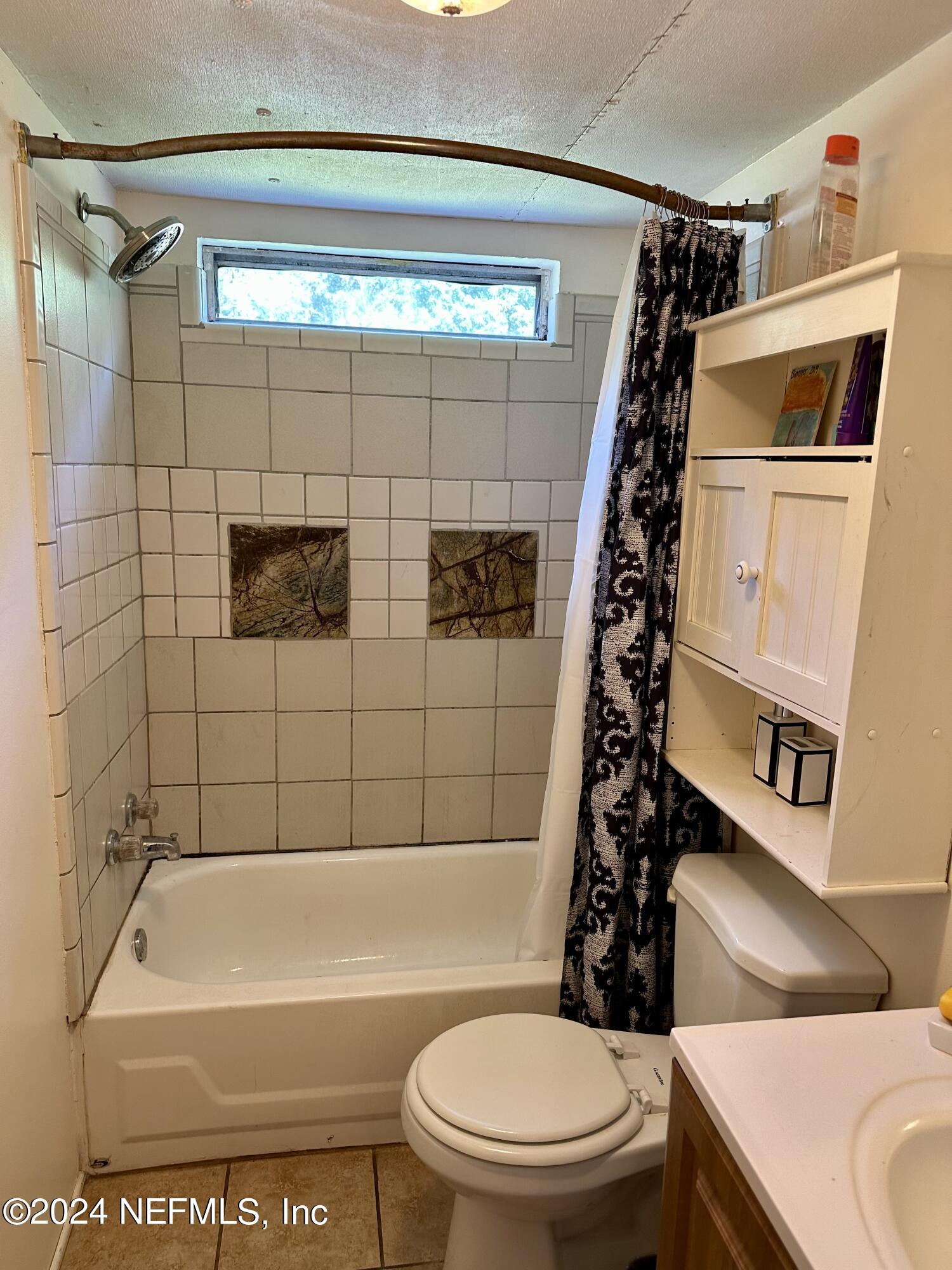 3140 Green Acres Road St. Augustine, FL 32084 - Photo 11 of 15 a bathroom with a toilet and a shower