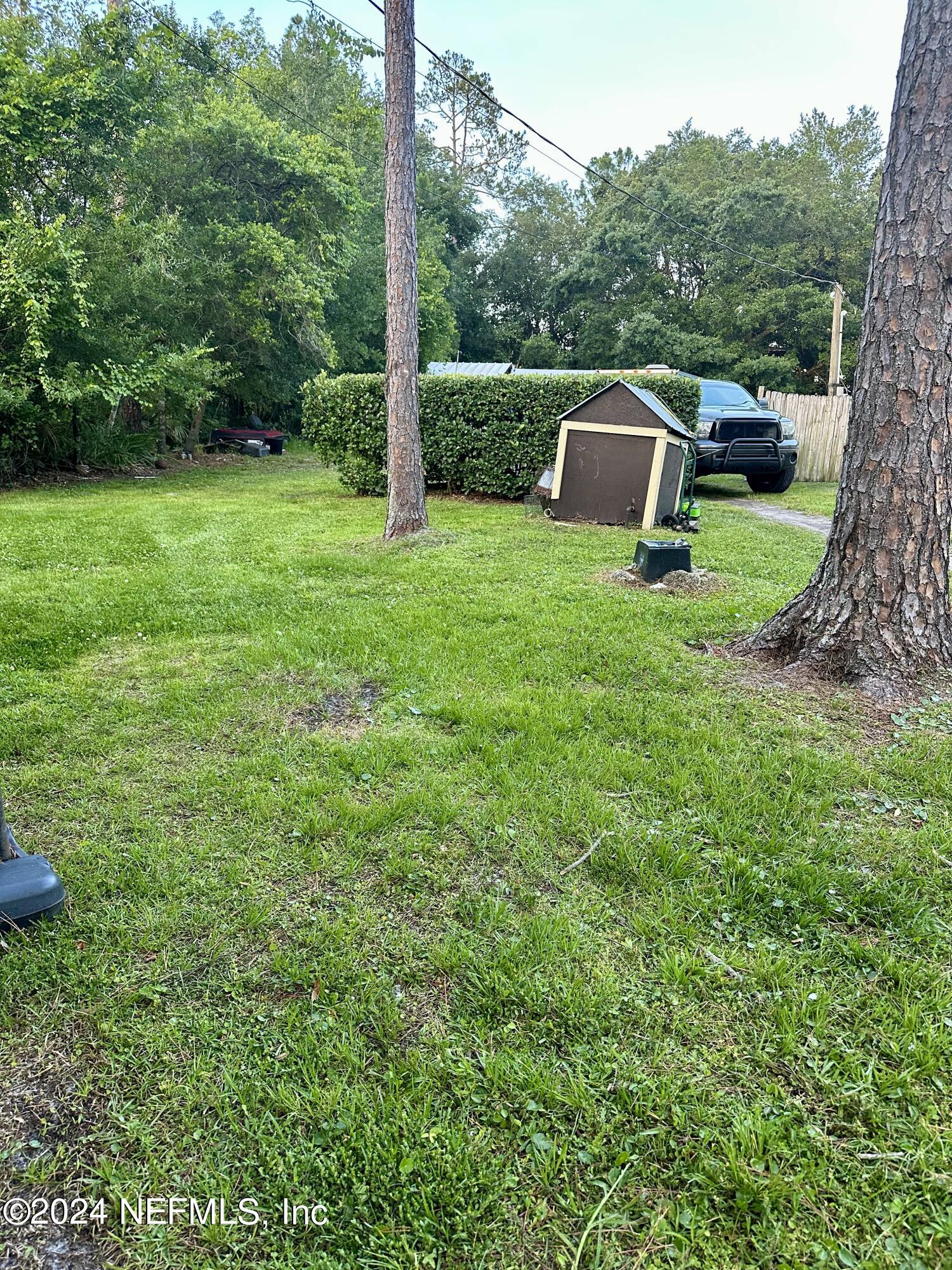 3140 Green Acres Road St. Augustine, FL 32084 - Photo 15 of 15 a view of a white house with a yard table and chairs