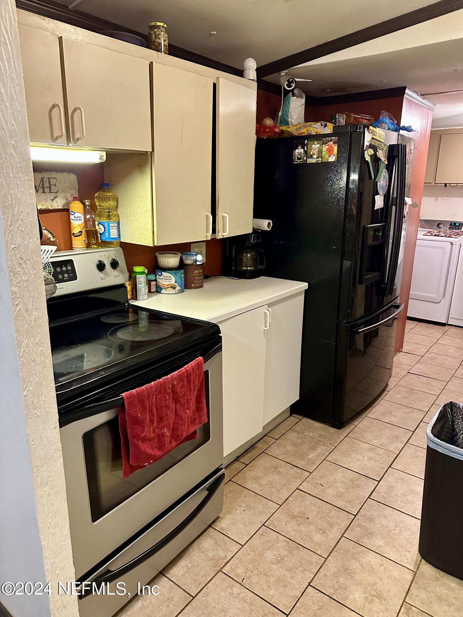 3140 Green Acres Road St. Augustine, FL 32084 - Photo 4 of 15 a kitchen with stainless steel appliances kitchen island granite countertop a refrigerator and a stove