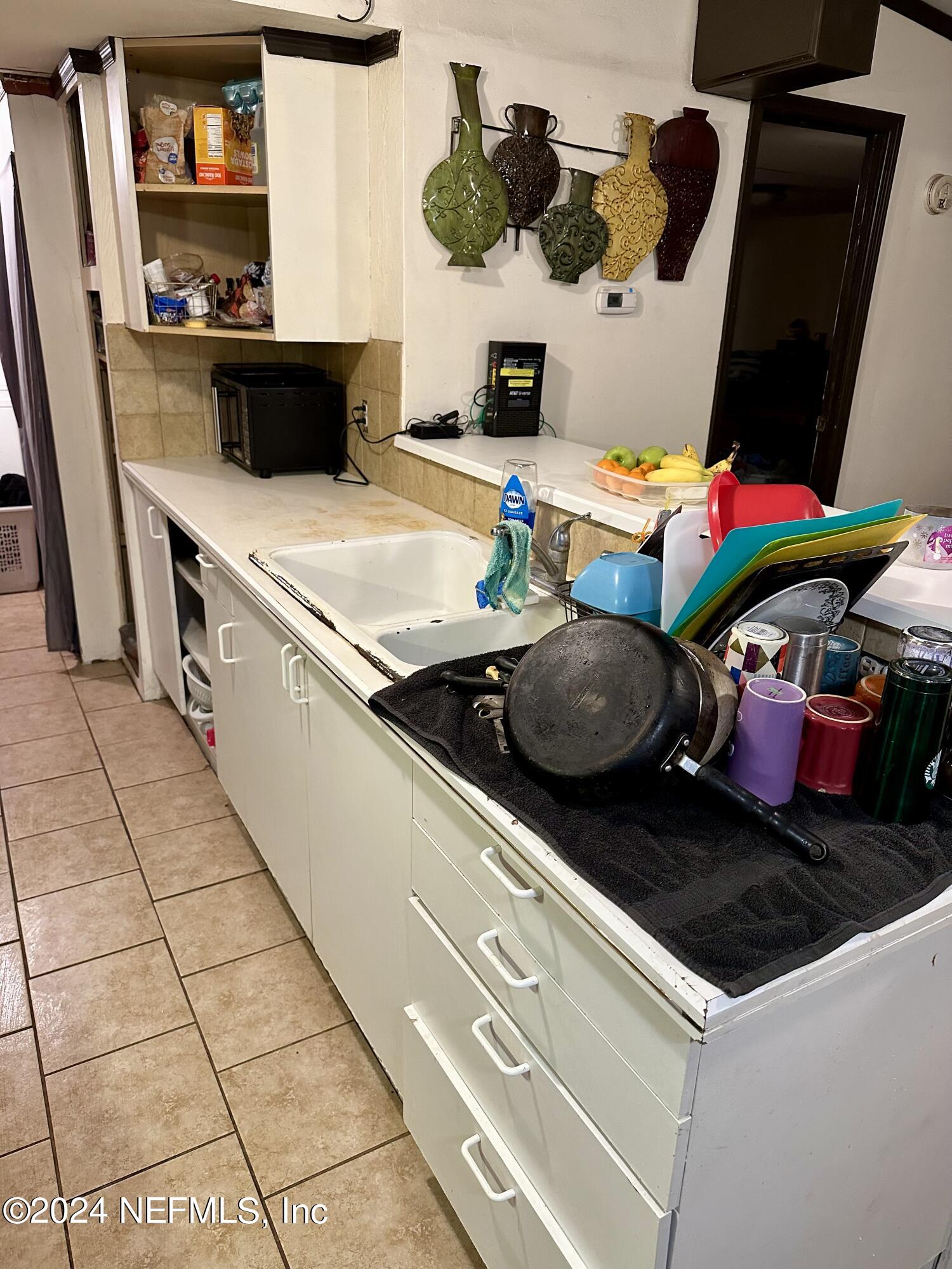 3140 Green Acres Road St. Augustine, FL 32084 - Photo 5 of 15 a kitchen with a sink and a stove with wooden floor