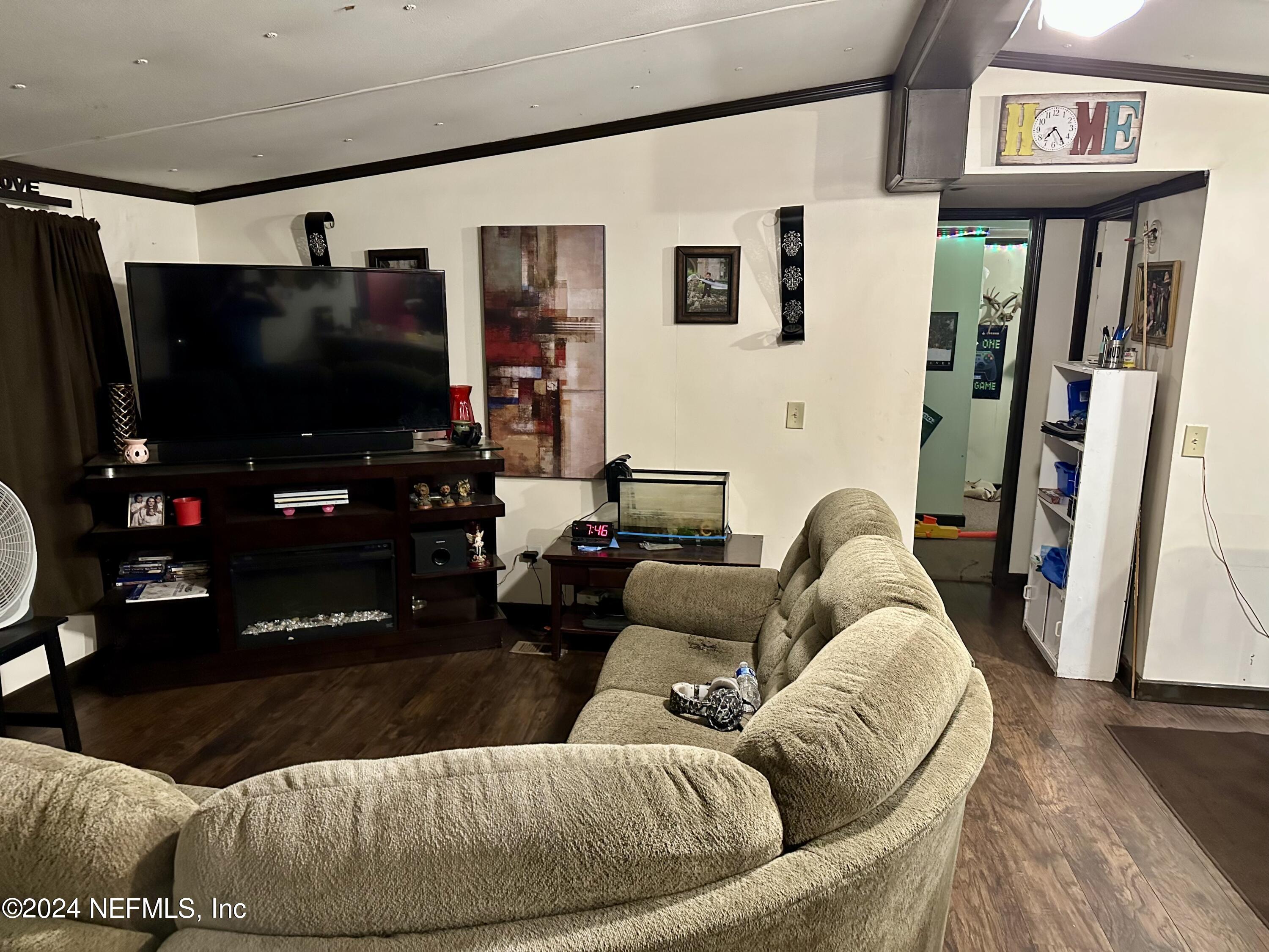 3140 Green Acres Road St. Augustine, FL 32084 - Photo 7 of 15 a living room with furniture and a flat screen tv