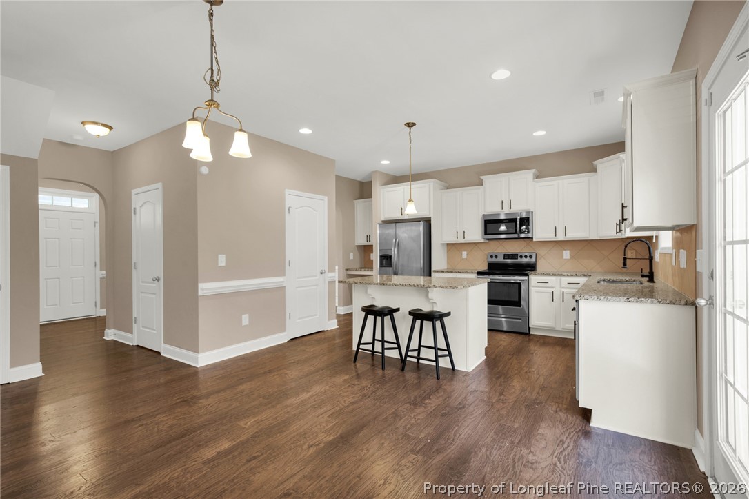 448 Pittfield Run Cameron, NC 28326 - Photo 12 of 43 a kitchen with a dining table chairs refrigerator and cabinets