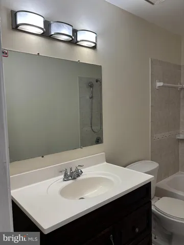 a bathroom with a bathtub a toilet and a shower