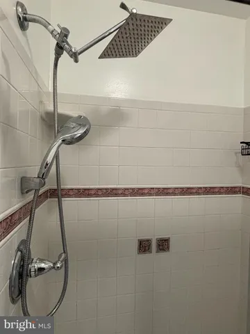 an empty room with wooden floor and bathroom