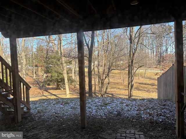 a view of a deck with wooden floor and a bench