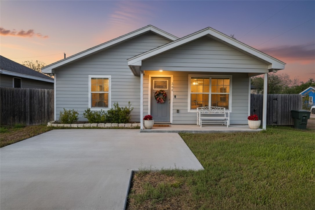 200 West 4th Street Alice, TX 78332 - Photo 1 of 19 a front view of a house with a yard and garage