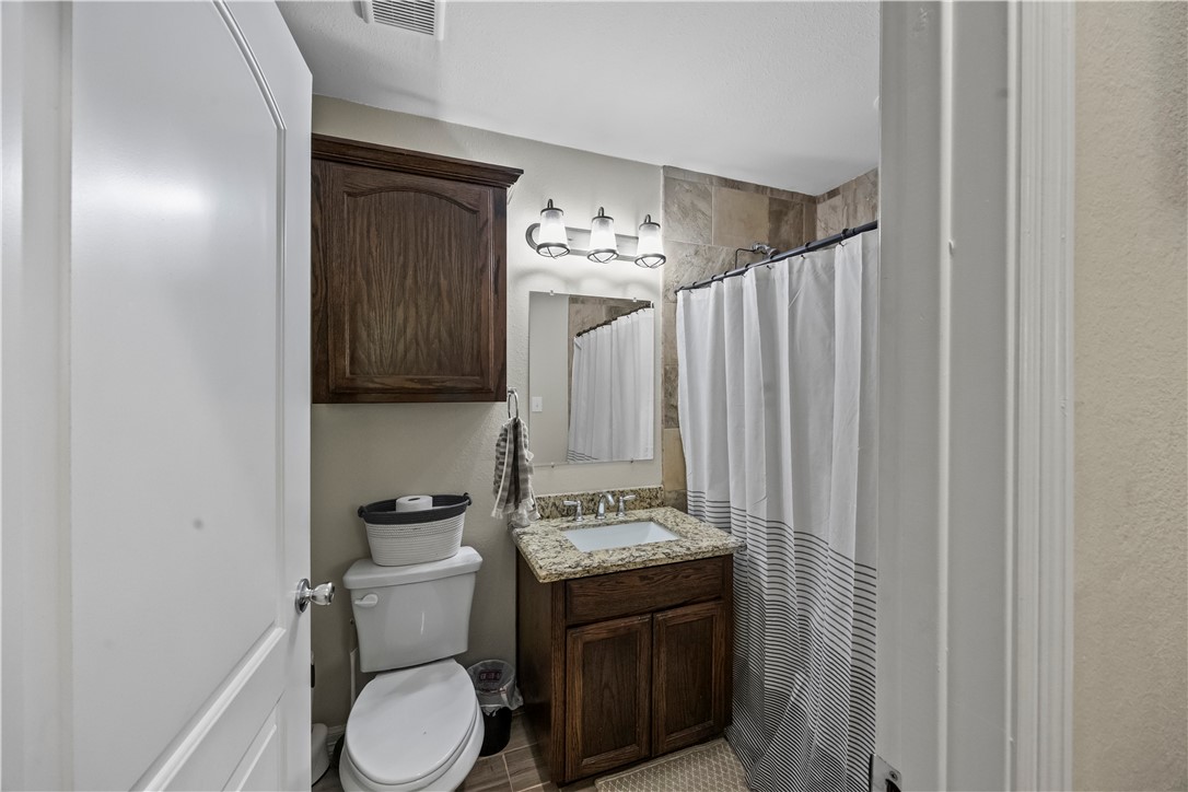 200 West 4th Street Alice, TX 78332 - Photo 11 of 19 a bathroom with a toilet sink and mirror