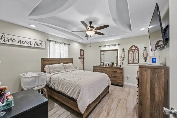 a bedroom with a large bed and a chandelier