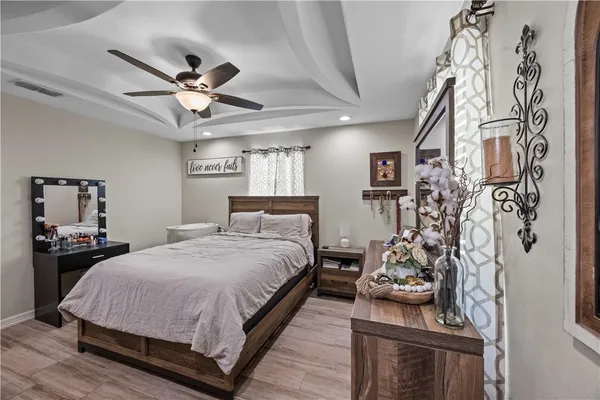 a bedroom with a bed and a chandelier