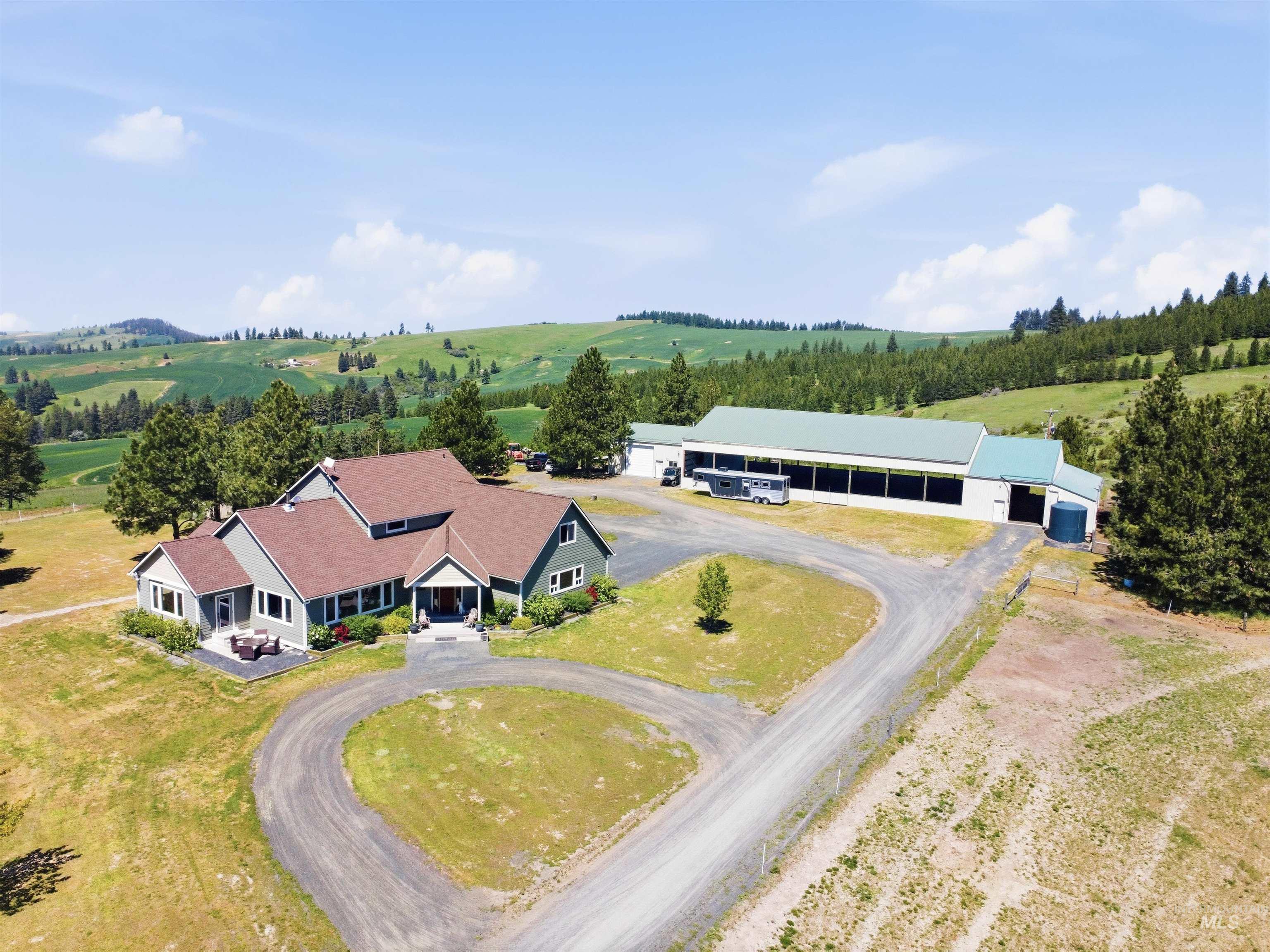 1049 Libey Road Viola, ID 83872 - Photo 1 of 43 Expansive property featuring a multi-gabled residence with a covered entryway and a separate large outbuilding with a green roof