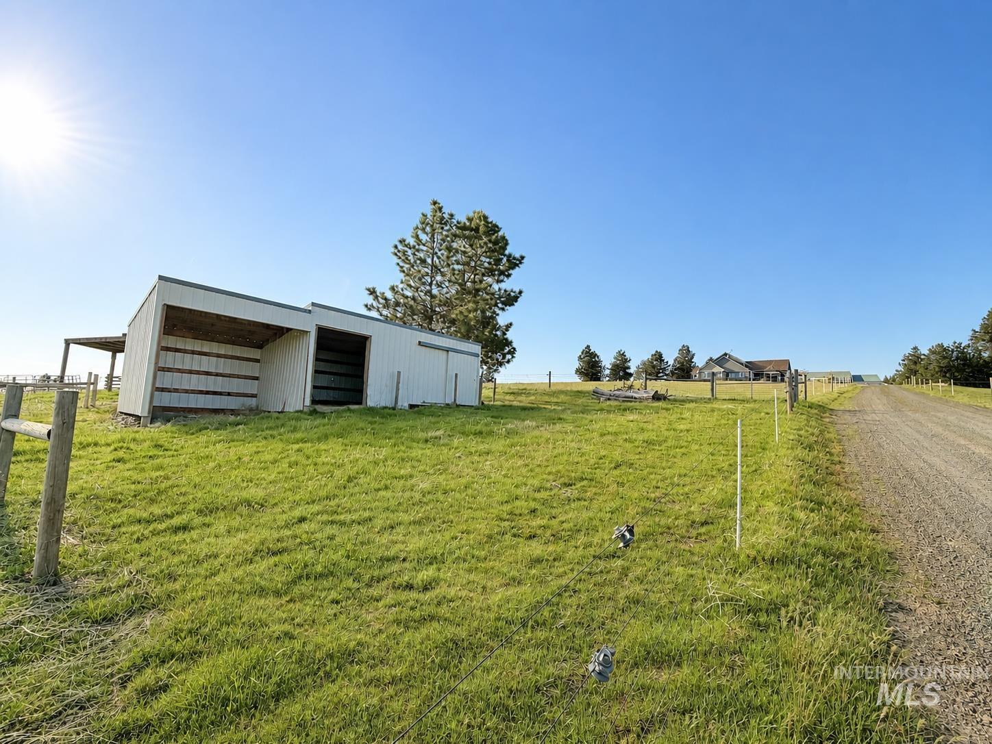 1049 Libey Road Viola, ID 83872 - Photo 24 of 43 White-sided outbuilding with multiple bays, set on a verdant hillside