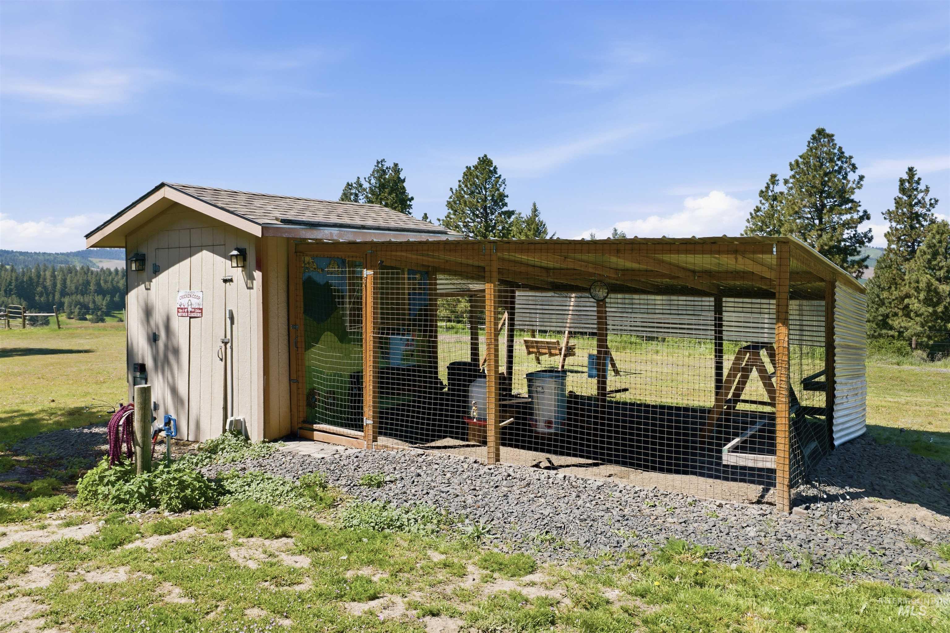 1049 Libey Road Viola, ID 83872 - Photo 27 of 43 Outbuilding featuring wood siding, an asphalt shingle roof, and a fenced, covered outdoor enclosure