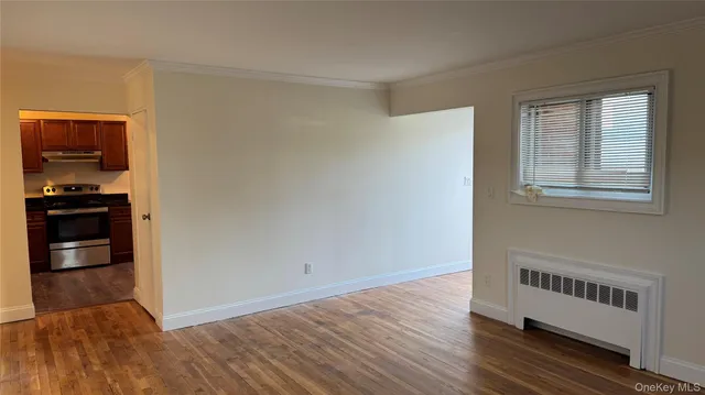a view of a livingroom with wooden floor and an empty space