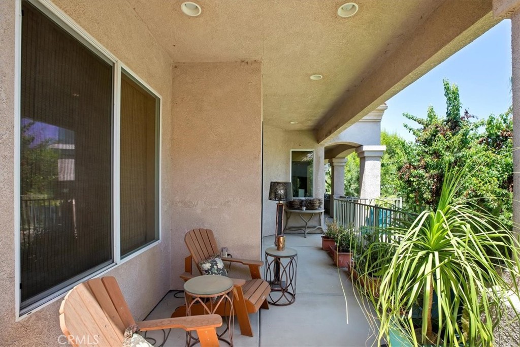 5614 Queen Palms Drive Riverside, CA 92506 - Photo 14 of 50 a view of a porch with chairs and potted plants