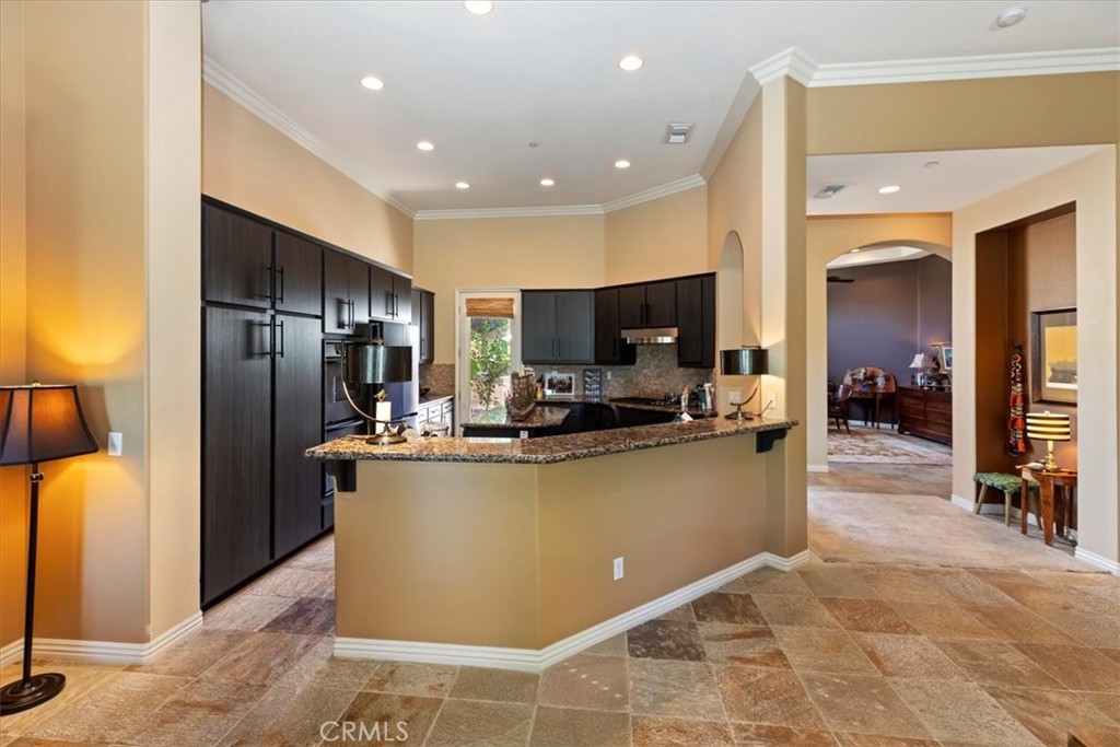 5614 Queen Palms Drive Riverside, CA 92506 - Photo 26 of 50 a view of a kitchen with kitchen island a counter top space and stainless steel appliances