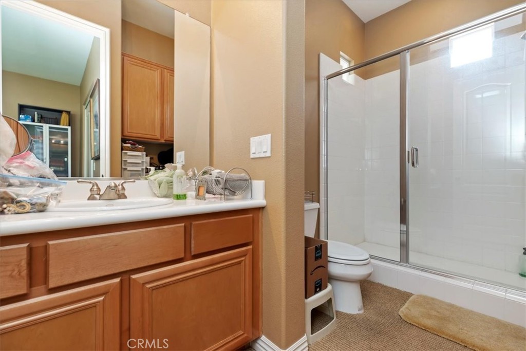 5614 Queen Palms Drive Riverside, CA 92506 - Photo 35 of 50 a bathroom with a double vanity sink toilet and shower