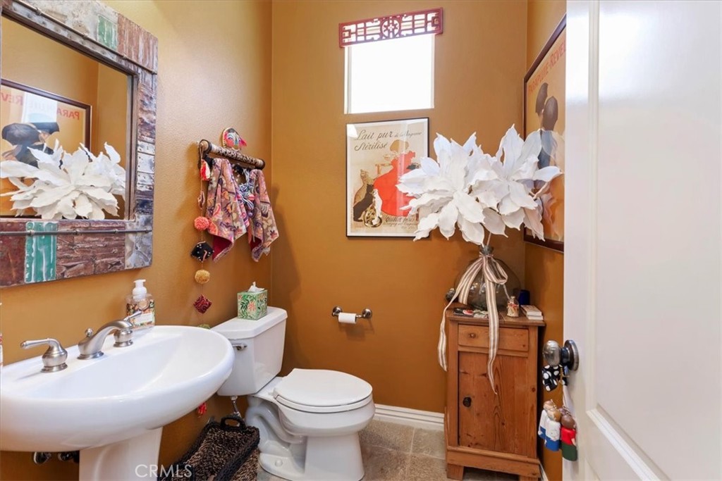 5614 Queen Palms Drive Riverside, CA 92506 - Photo 37 of 50 a bathroom with a sink mirror and toilet