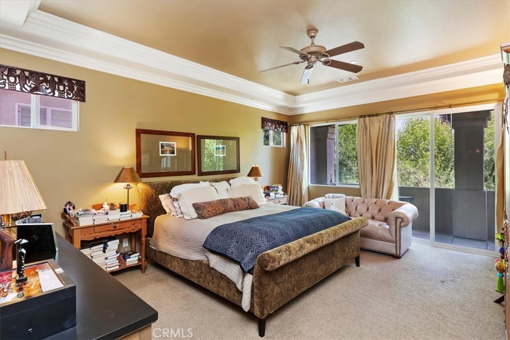 5614 Queen Palms Drive Riverside, CA 92506 - Photo 42 of 50 a spacious bedroom with a bed and a chandelier