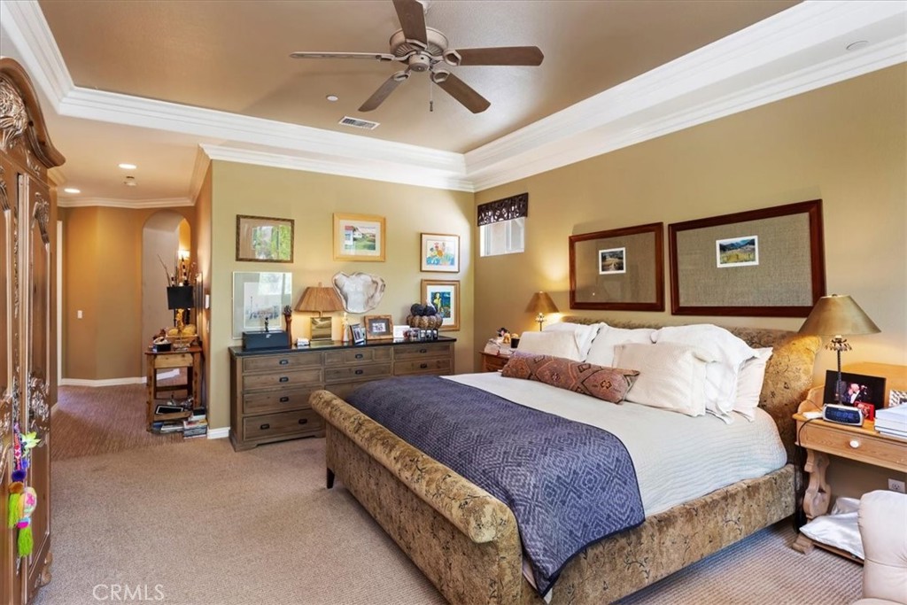 5614 Queen Palms Drive Riverside, CA 92506 - Photo 43 of 50 a spacious bedroom with a bed and ceiling fan