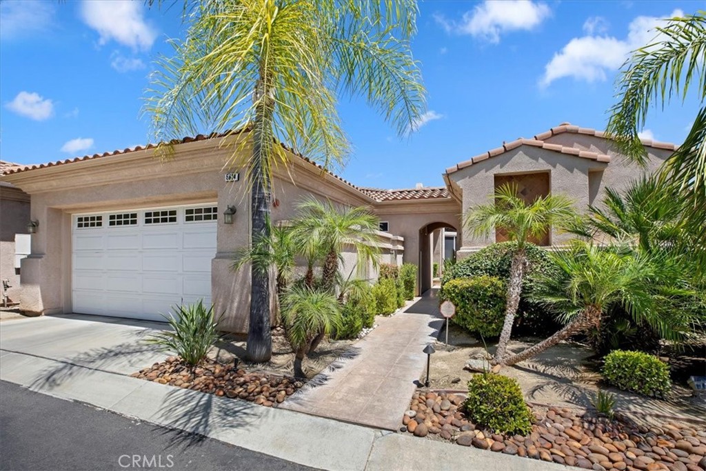 5614 Queen Palms Drive Riverside, CA 92506 - Photo 5 of 50 a front view of a house with a yard