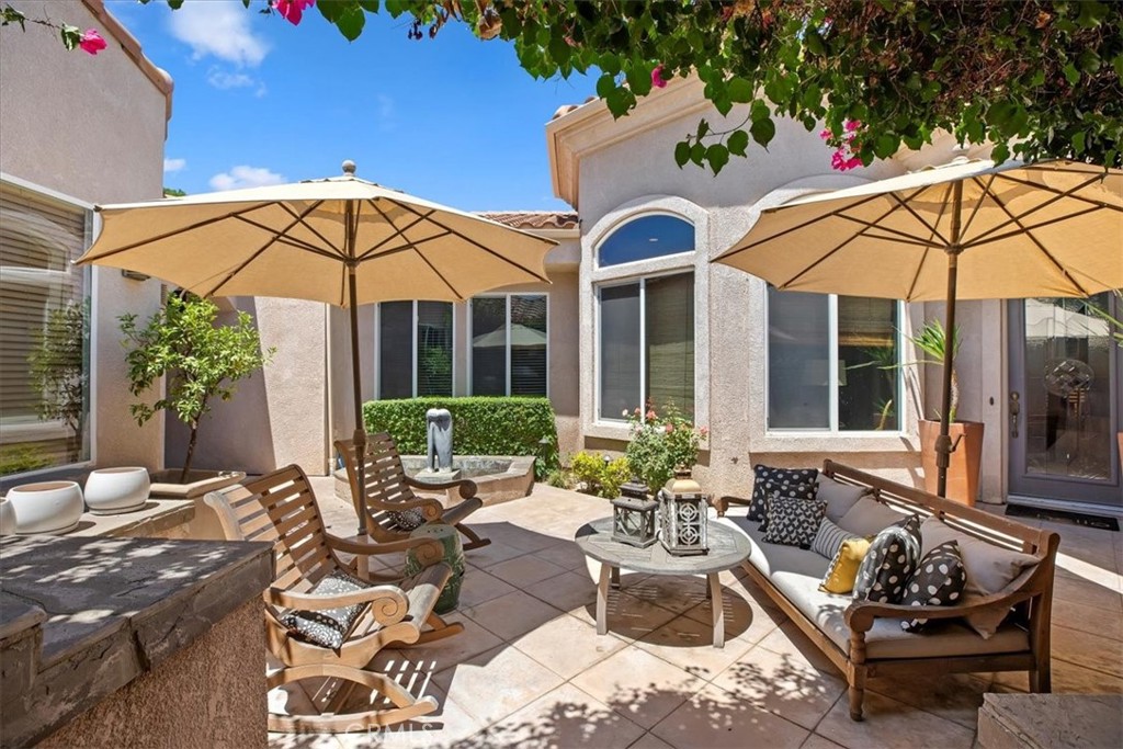 5614 Queen Palms Drive Riverside, CA 92506 - Photo 8 of 50 a view of a white house with a yard patio and furniture