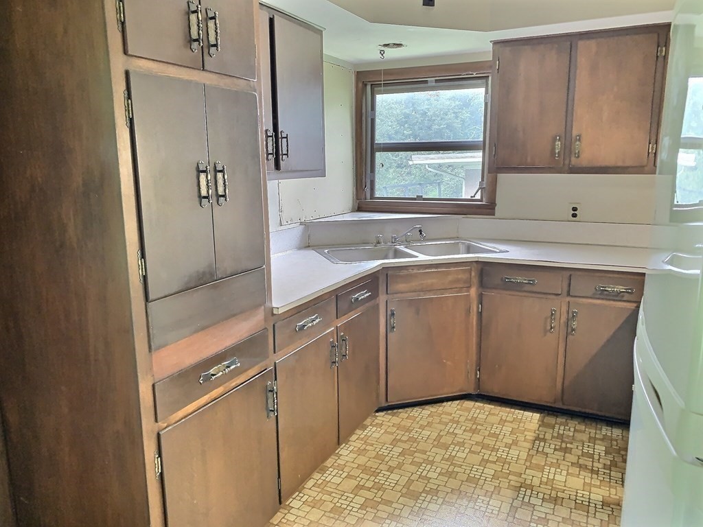 330 Hollis Road Lunenburg, MA 01462 - Photo 10 of 22 a kitchen with a sink cabinets appliances and a window