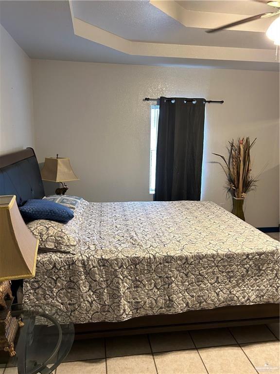 9433 North Minnesota Road Mission, TX 78574 - Photo 11 of 17 Bedroom with tile patterned floors and a raised ceiling