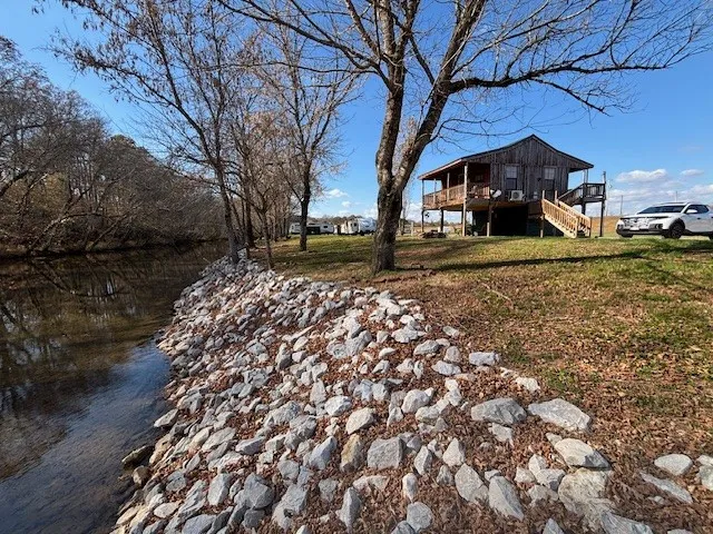 a bed sitting in a bedroom next to a lamp
