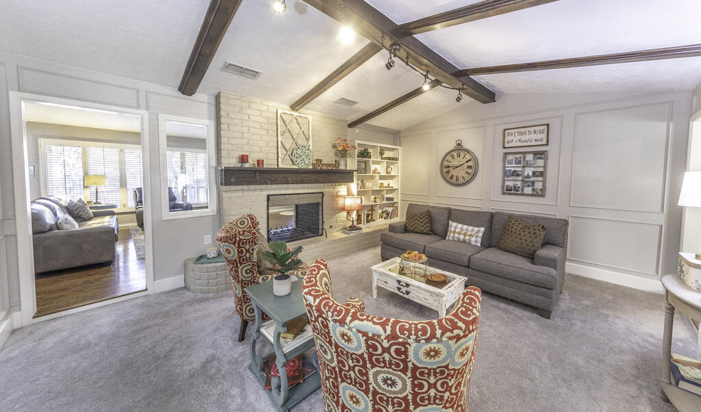 3620 93rd Street Lubbock, TX 79423 - Photo 5 of 33 a living room with furniture and a fireplace