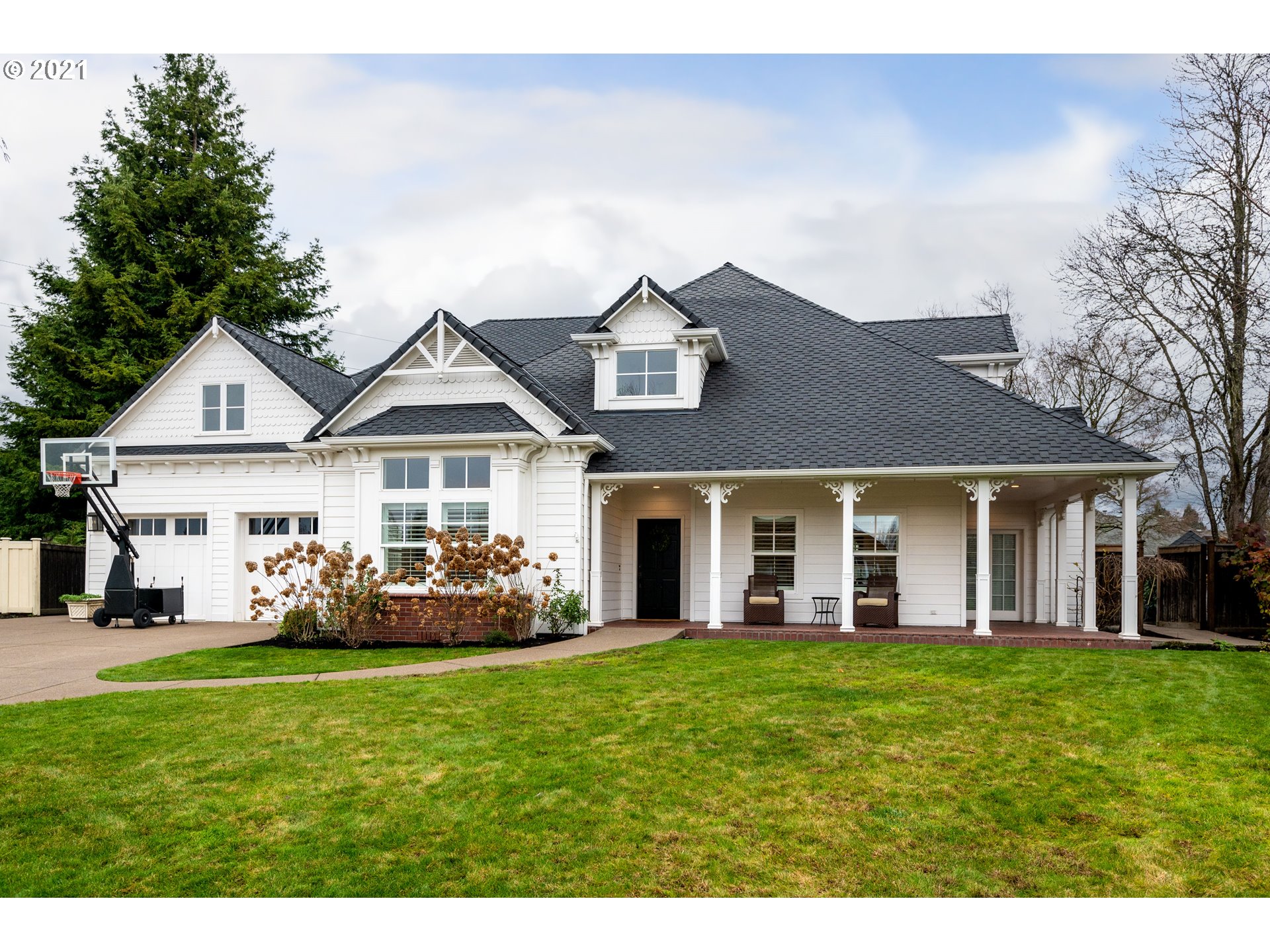 1703 Victorian Way Eugene, OR 97401 - Photo 1 of 32 a front view of a house with a garden and yard