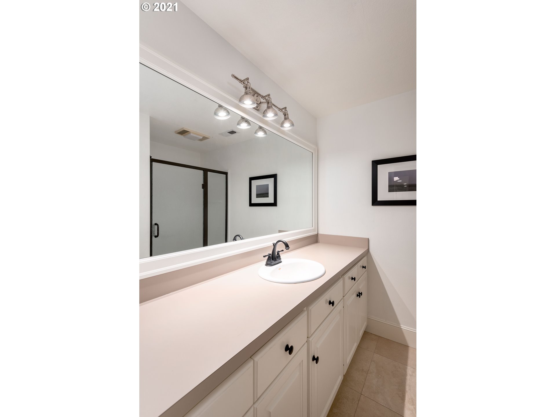 1703 Victorian Way Eugene, OR 97401 - Photo 20 of 32 a en suite bathroom with a sink and a mirror