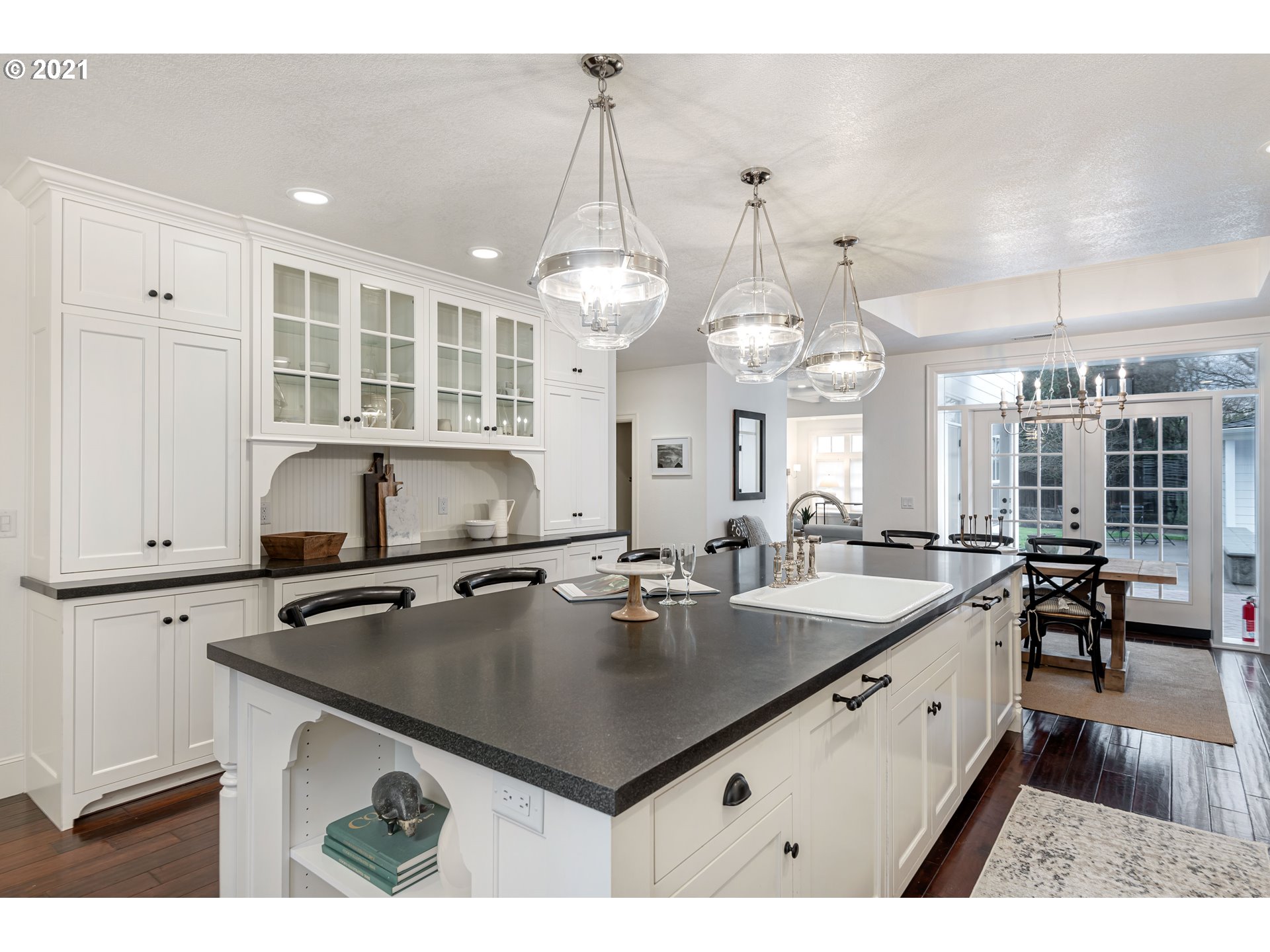 1703 Victorian Way Eugene, OR 97401 - Photo 6 of 32 a kitchen with kitchen island a sink counter space and living room view