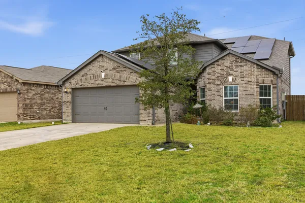 a front view of a house with a yard