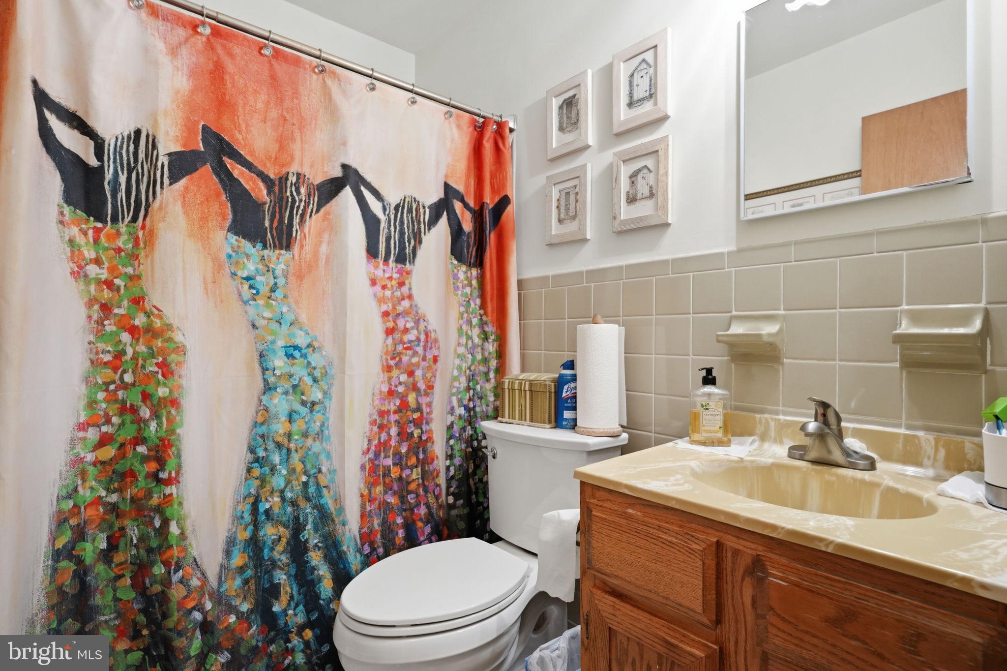 318 Warwick Road Lawnside, NJ 08045 - Photo 19 of 25 Vibrant art adds flair to the bath.