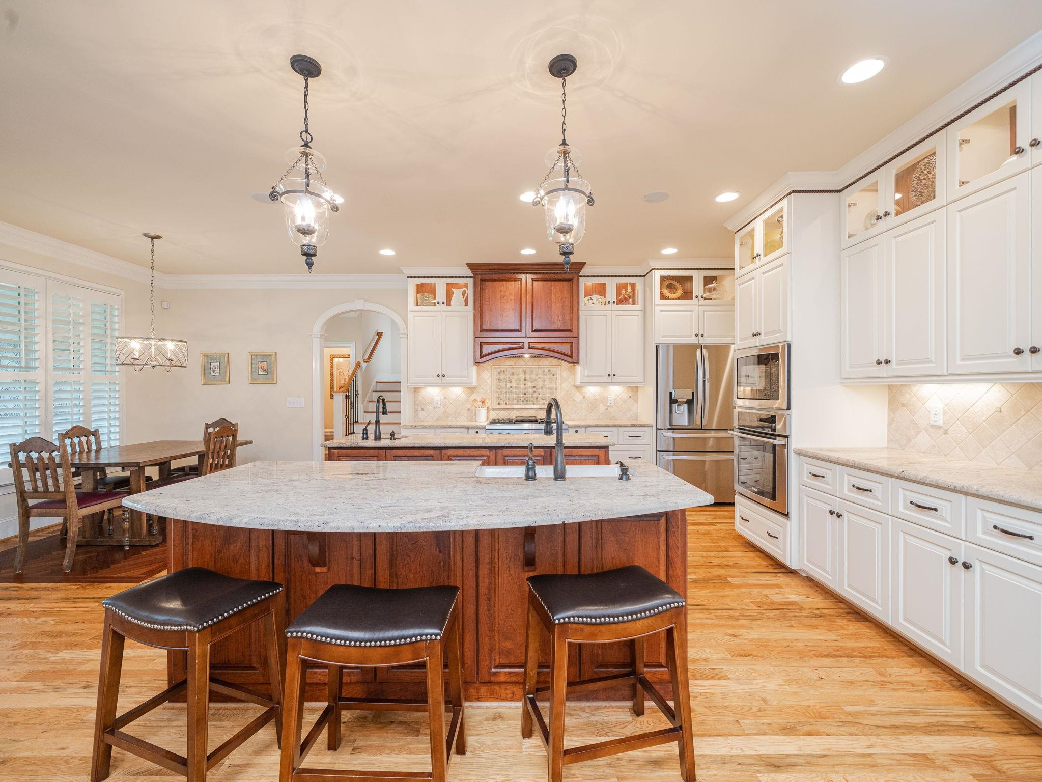 842 Cranbrook Road Raleigh, NC 27609 - Photo 9 of 39 Double Island with prep sink, Thermador Appliances, custom cabinets with soft close features on the drawers and doors. Recessed lighting, upper cabinet lighting and under cabinet lighting design features. Kitchen