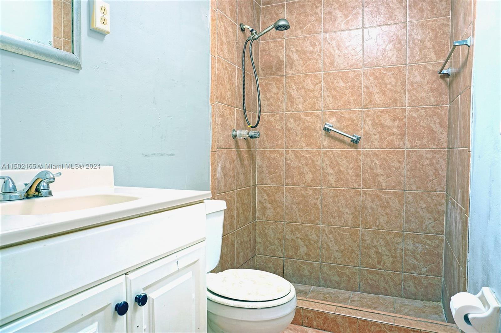 2496 North Pine Island Road Sunrise, FL 33322 - Photo 13 of 15 a bathroom with a sink a toilet and shower