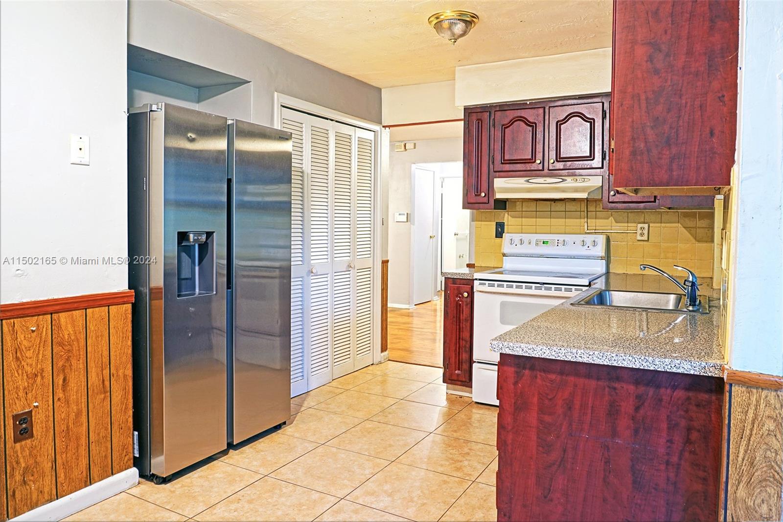 2496 North Pine Island Road Sunrise, FL 33322 - Photo 7 of 15 a kitchen with stainless steel appliances granite countertop a refrigerator and a sink