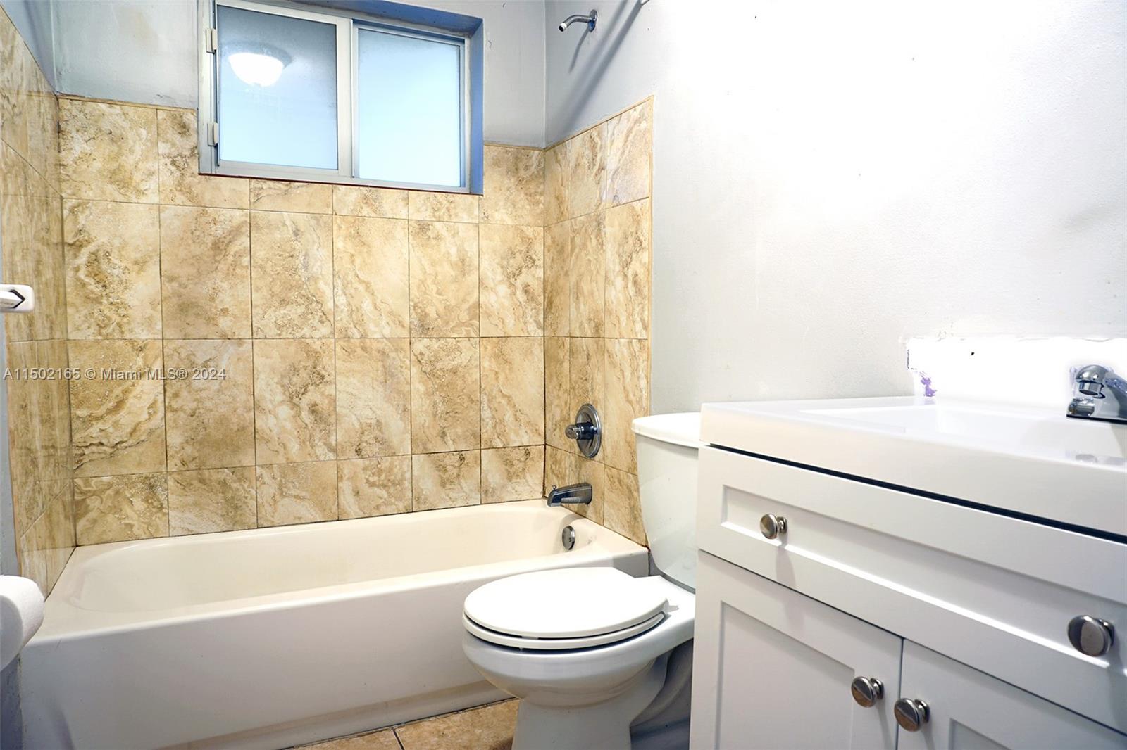 2496 North Pine Island Road Sunrise, FL 33322 - Photo 10 of 15 a bathroom with a sink a toilet and a bathtub