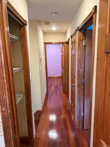 a view of hallway with wooden floor