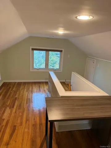 a view of a workspace with furniture and wooden floor