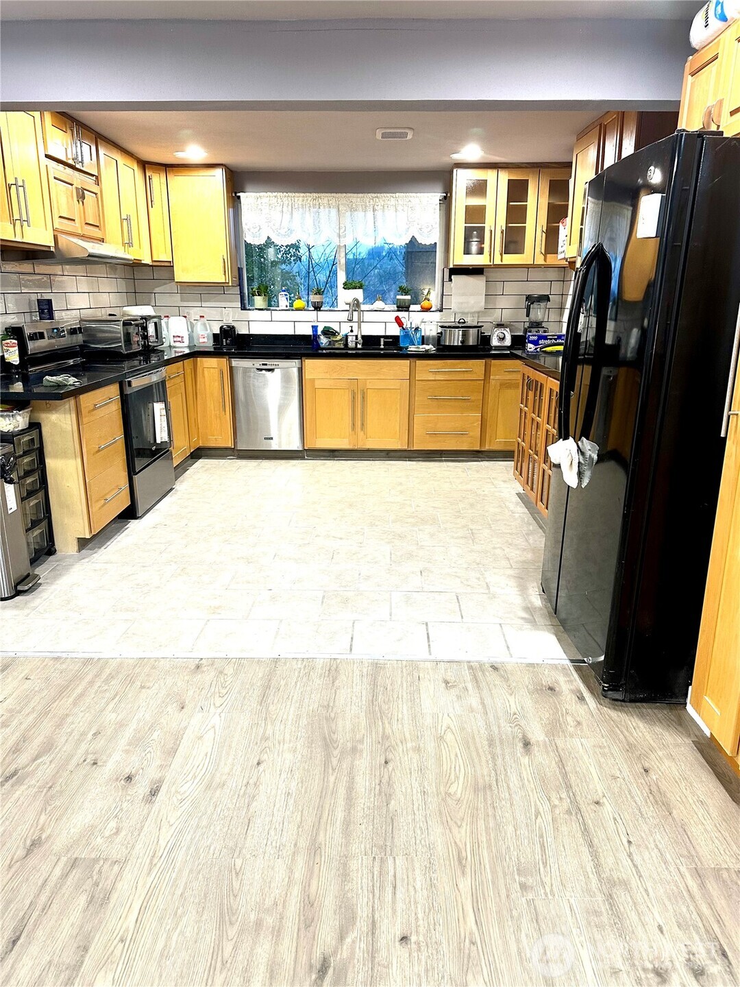 1302 Southwest Bay Street Port Orchard, WA 98366 - Photo 14 of 17 a large kitchen with stainless steel appliances wooden floor and a counter top space